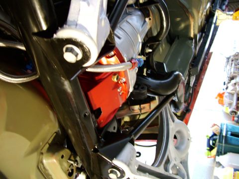 2003 Ford Mustang - A close-up view of the undercarriage of a vehicle, showing mechanical components and suspension parts.