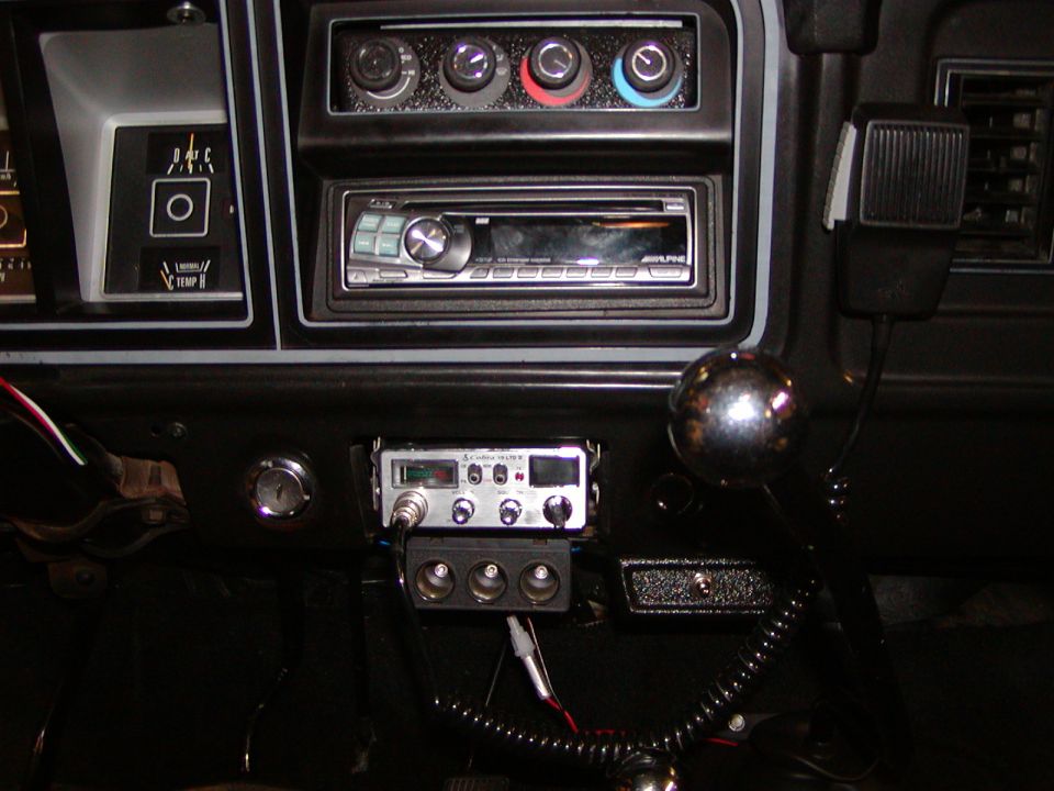 1978 Ford Bronco interior dashboard with Alpine stereo, Cobra CB radio, and chrome shift knob
