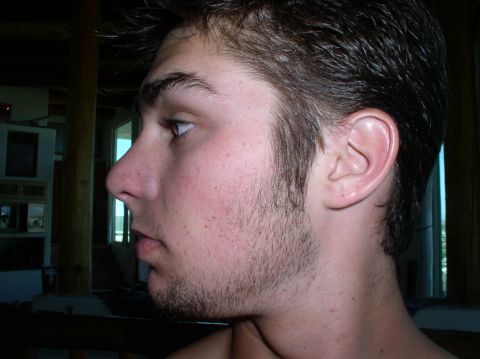 1990 Ford Bronco - Young man's profile, wearing a Supermotors.net t-shirt.