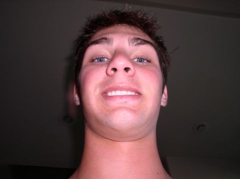 1990 Ford Bronco - A close-up selfie captures a young man with blue eyes and short brown hair, looking directly into the camera.