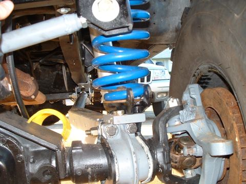 1995 Ford Bronco - Suspension components are visible, with a white SUV in the background.