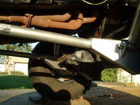 1995 Ford Bronco - Close-up view of the undercarriage, showing the rear axle and exhaust system of a vehicle.