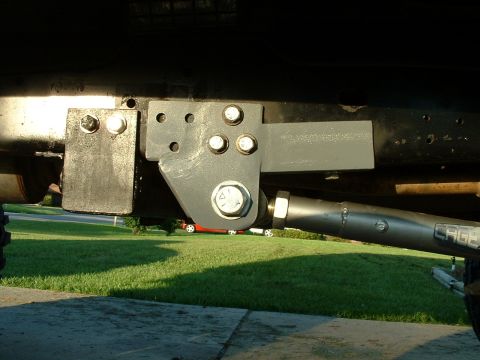 1995 Ford Bronco - Custom suspension part attached to the underside of a vehicle, with 'CAGE' branding visible on the component.