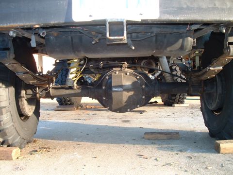 1995 Ford Bronco - Undercarriage view showing the rear axle, suspension, and fuel tank of a vehicle.
