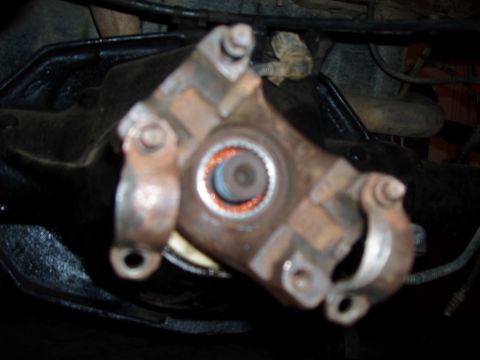 1994 Ford Bronco - Driveshaft universal joint detail, showing wear and orange sealant.