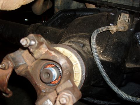 1994 Ford Bronco - This image shows a close-up view of a vehicle's rear differential and driveshaft connection, including a sensor wire.
