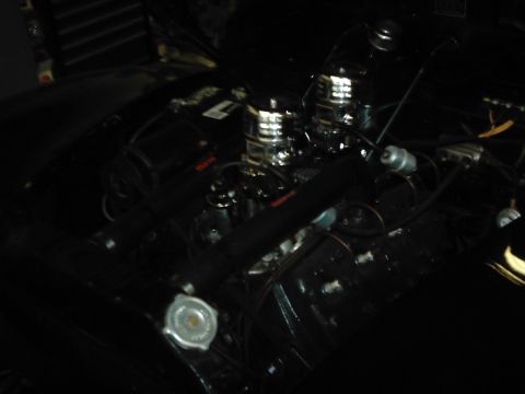 1978 Ford Bronco - Close-up of a vehicle's engine bay, dual carburetors and various engine components.