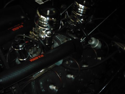 1978 Ford Bronco - Close-up view of a modified engine bay with prominent chrome components and black hoses.