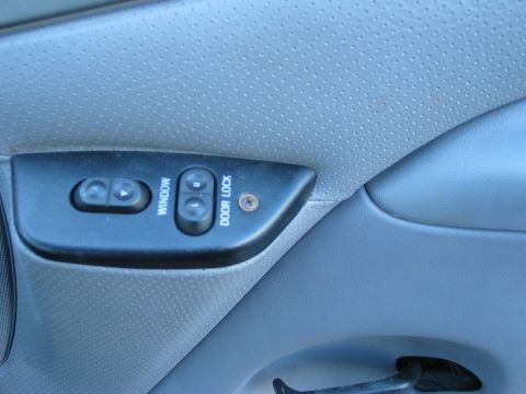 1995 Ford Bronco - Close-up of a car's interior door panel, showing the power window and door lock controls.