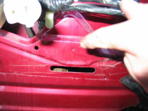 1995 Ford Bronco - Interior view of a car door showing internal components and wiring harness.
