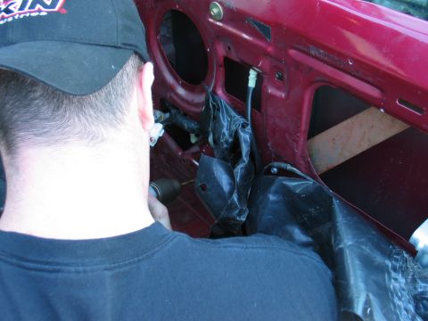 1995 Ford Bronco - Working on the interior of a car door, possibly for window motor repair.