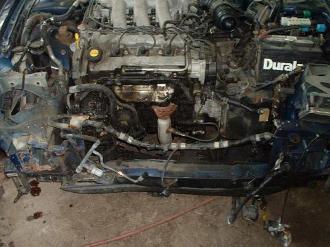 1994 Ford Probe - The engine bay of a vehicle, showing the Ford engine block and various components.
