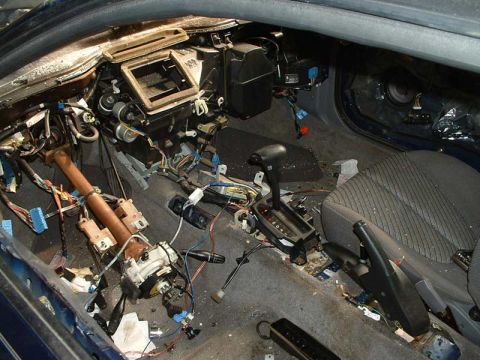 1994 Ford Probe - Interior of a car with dashboard and console removed, exposing wiring and components.