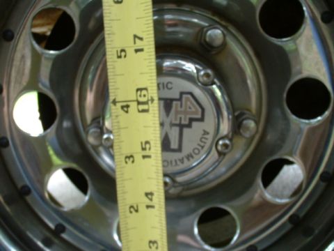 1991 Ford Bronco - A close-up of a wheel hub with a measuring tape, indicating '4x4 AUTOMATIC'.