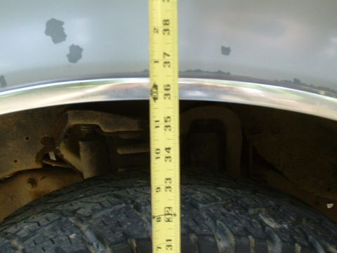 1991 Ford Bronco - Measuring the suspension height of a 1991 Ford Bronco, showing approximately 35 inches from the tire to the fender.