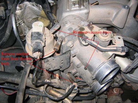 1994 Ford Bronco - Close-up view of an engine's throttle body, showing labeled vacuum lines and coolant hoses.