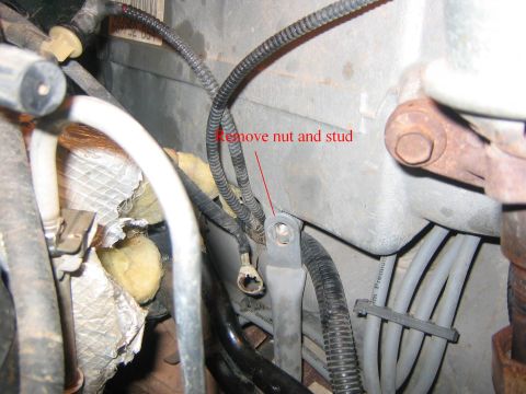 1994 Ford Bronco - Engine bay detail showing wiring and hoses, with instructions to remove a nut and stud.