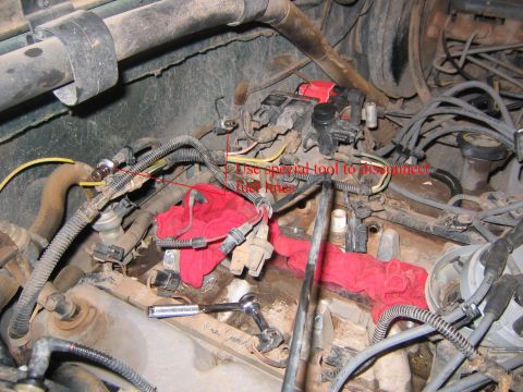 1994 Ford Bronco - Close-up view of an engine bay, focusing on fuel injectors and associated components, with instructional text.
