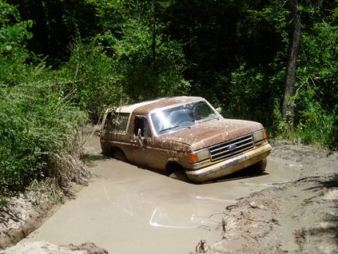 1987 Ford Bronco - This 1987 Ford Bronco is stuck in the mud on a trail.