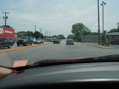 1997 Ford Taurus - A view from inside a vehicle looking out at traffic on a sunny day.