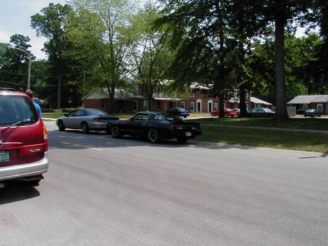 1997 Ford Taurus - A black 1981 Chevrolet Camaro Z28 is parked on the street, with other vehicles visible.