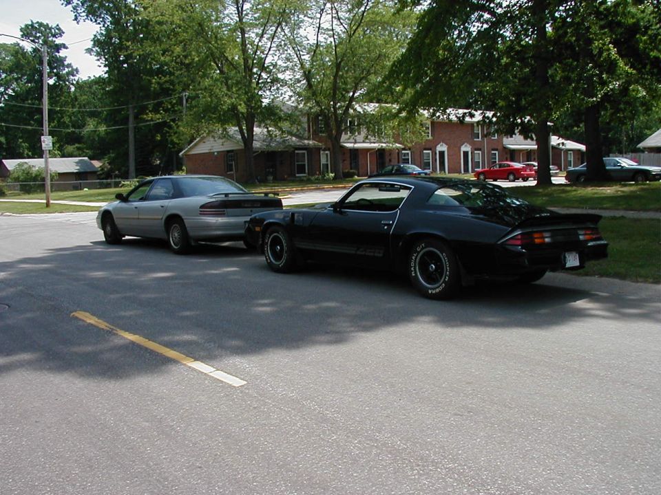 Black 1978 Chevrolet Camaro Z28 and silver sedan parked on street
