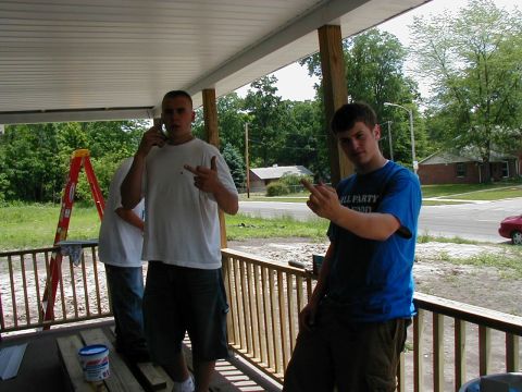 1997 Ford Taurus - Two men stand on a porch, with a red ladder visible in the background.