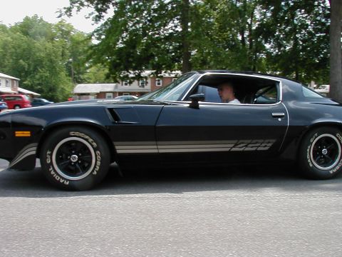 1997 Ford Taurus - This black 1978 Chevrolet Camaro Z28 is seen from the side, Cooper Cobra tires and distinctive Z28 badging.