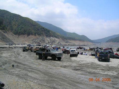 1985 Ford Bronco - Off-road vehicles gathered in a canyon on a sunny day.