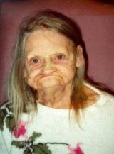 1986 Ford Bronco - An elderly woman with a distinctive facial expression is shown, with a website address visible at the bottom of the image.