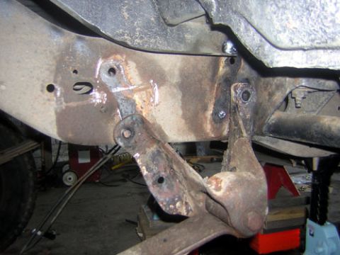 1995 Ford Bronco - bracket-be gone Had to clearence the body a bit with a torch to get access at the top bolts, and torched off the heads on the bottom rivets