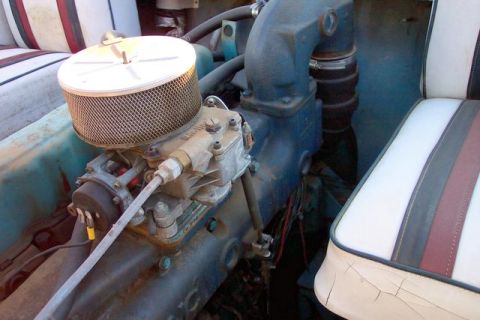1990 Ford Bronco - Close-up of an engine compartment and part of the interior seating.