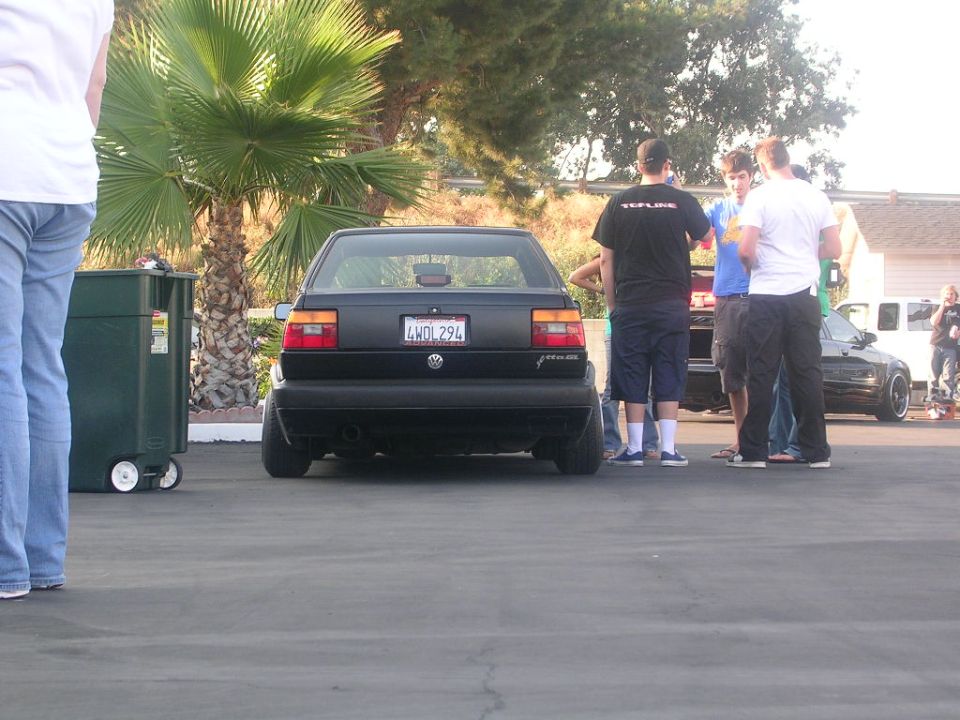 Black Volkswagen Jetta GLI with license plate 4WDL294 parked outdoors