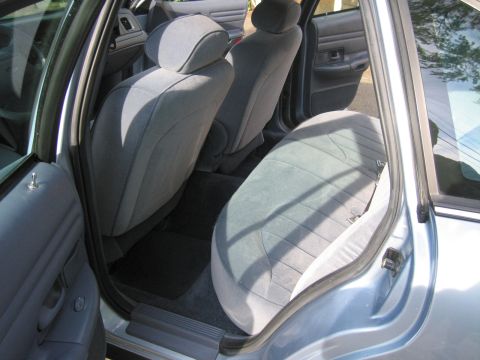1991 Ford LTD Crown Victoria - The interior of a 1991 Ford Crown Victoria LTD is visible, with light blue cloth seats and door panels.