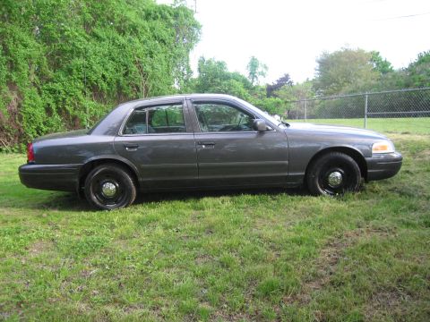 1991 Ford LTD Crown Victoria - This 1991 Ford Crown Victoria LTD is shown from its side profile, parked on a grassy area.