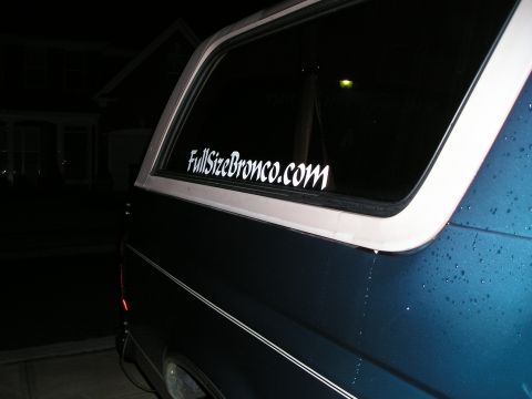 1996 Ford Bronco - A dark blue SUV is seen from the rear quarter, a "FullSizeBronco.com" sticker on its window.