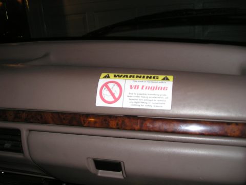 1996 Ford Bronco - Interior dashboard view showing a warning sticker about the V8 engine.
