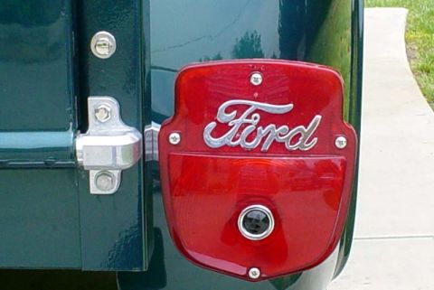 1956 Ford F-100 - Close-up of the red taillight assembly on a 1956 Ford F-100, the iconic Ford script emblem.
