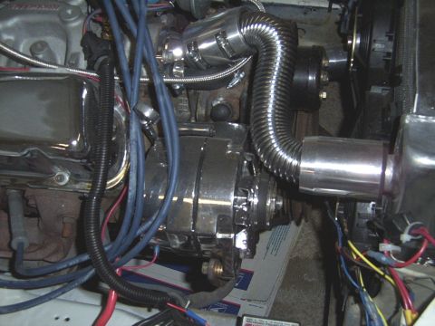 1978 Ford Mustang II - The engine bay shows a chrome alternator and various hoses and wires connected to the engine block.