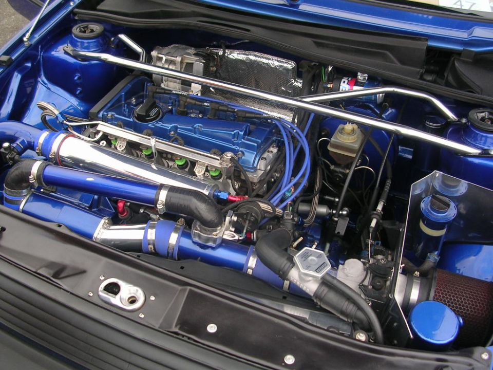 Blue engine bay with chrome and blue piping, strut bar