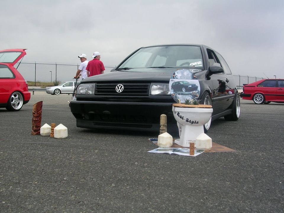 Black Volkswagen Jetta with a toilet display, front view. Modified
