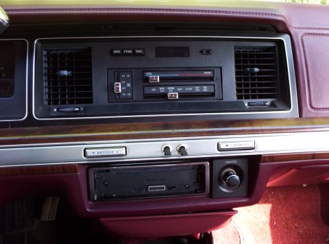 1991 Ford LTD Crown Victoria - Close-up of a car's center console, showing the climate controls and aftermarket stereo system.