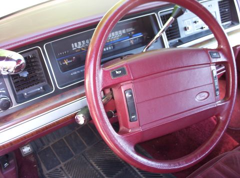1991 Ford LTD Crown Victoria - Interior view of a 1991 Ford Crown Victoria LTD, highlighting the burgundy dashboard and steering wheel.