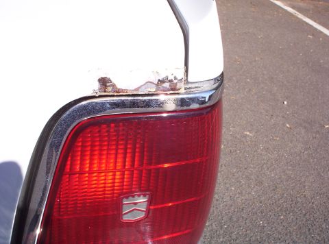 1991 Ford LTD Crown Victoria - Rust is visible on the rear quarter panel of a 1991 Ford Crown Victoria LTD, above the taillight.