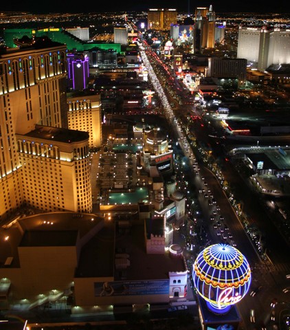 2002 Ford Mustang - A nighttime aerial view of the Las Vegas Strip shows a busy street lined with brightly lit hotels and casinos.