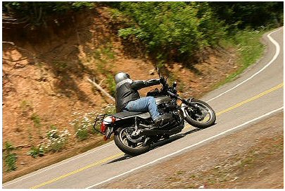 1985 Ford Crown Victoria LTD - Rider leans into a turn on a scenic mountain road.