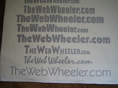 1990 Ford Bronco - photo of a printed page displaying the TheWebWheeler.com wordmark in multiple typefaces, not a vehicle technical document.