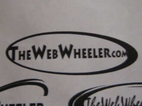 1990 Ford Bronco - photo of a printed TheWebWheeler.com oval logo design, not a vehicle technical document.