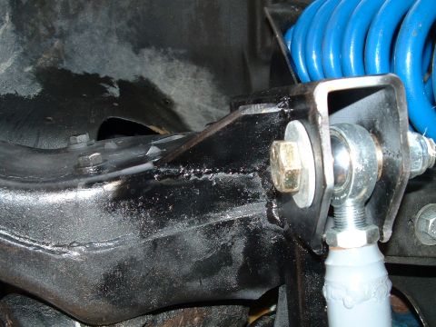 1995 Ford Bronco - Suspension component with a blue coil spring and a ball joint visible.