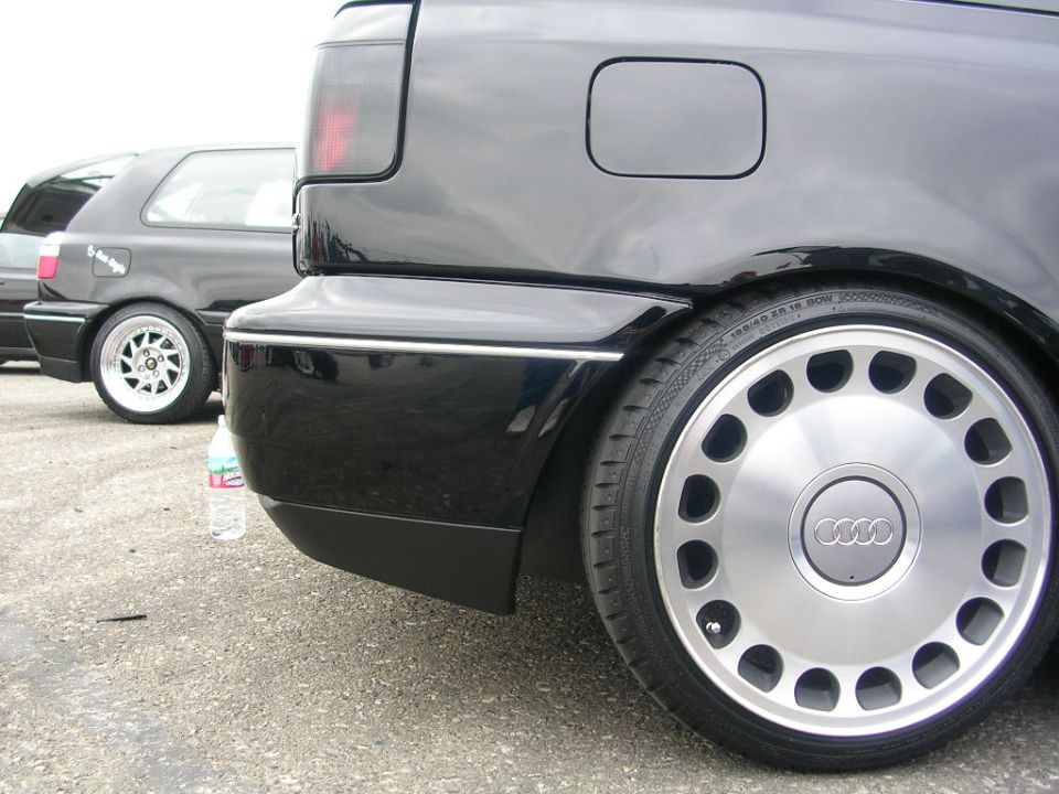 Black Audi rear quarter panel with unique multi-hole wheels